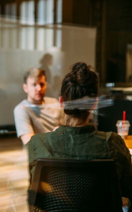 person sitting in a chair in front of a man